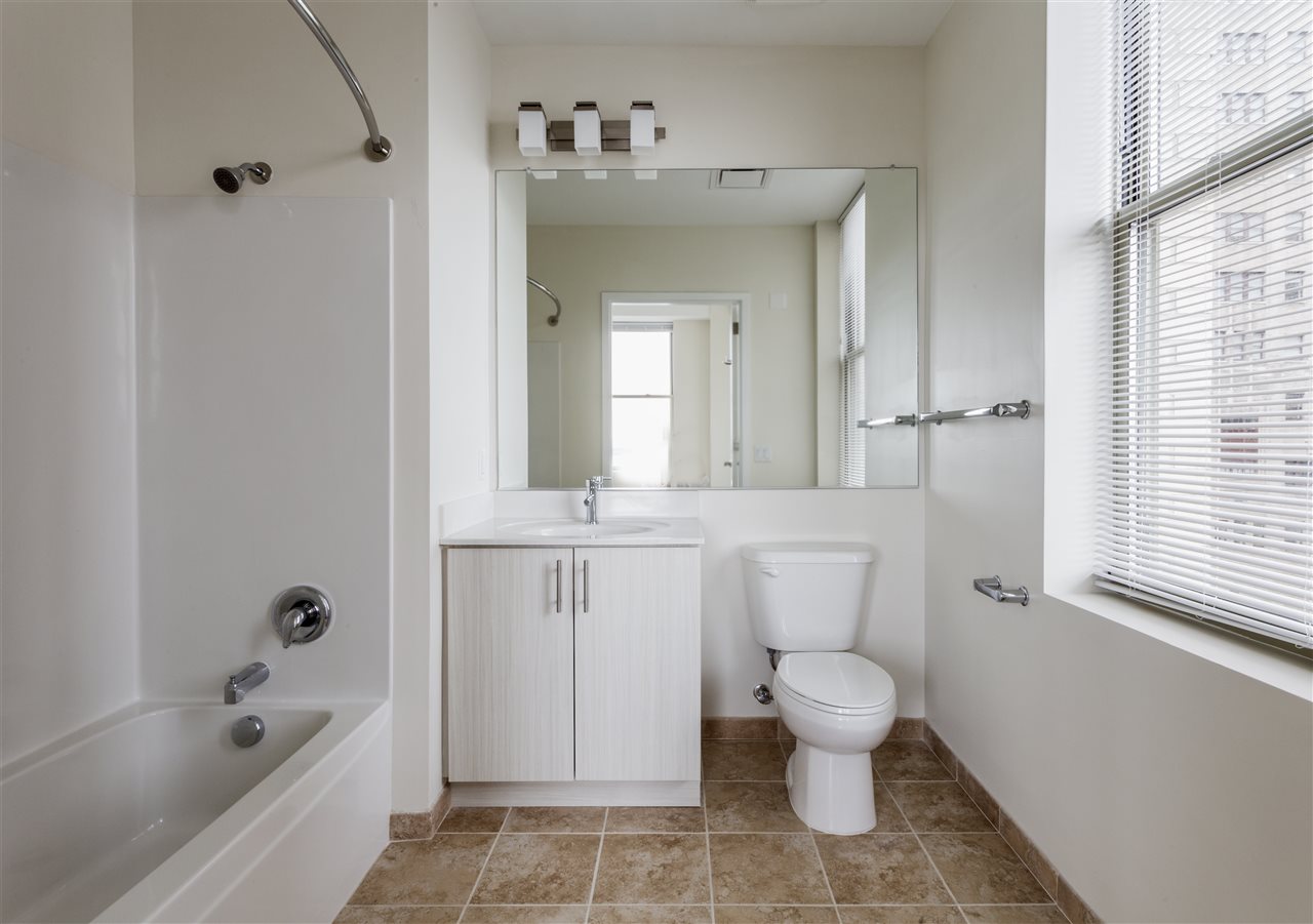 88 Clifton Place, Unit 201 Jersey City, NJ 07304 - Photo 2 of 10 a bathroom with a toilet sink and a bathtub