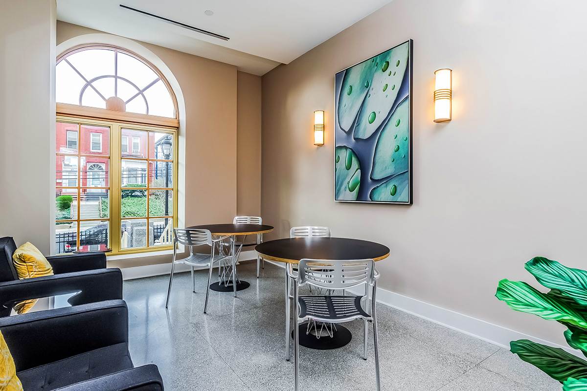 88 Clifton Place, Unit 201 Jersey City, NJ 07304 - Photo 10 of 10 a dining room with wooden floor a glass table and chairs