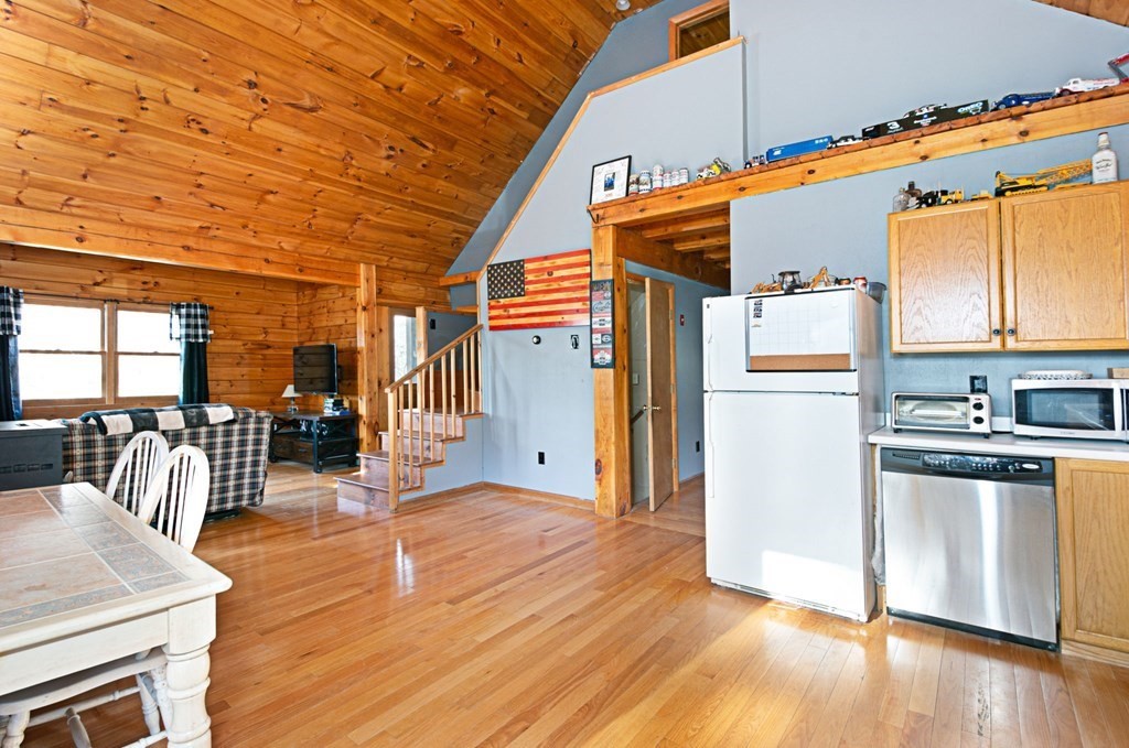 256 Ware Corner Road Oakham, MA 01068 - Photo 6 of 33 a open kitchen with stainless steel appliances granite countertop a refrigerator a stove and a wooden floors