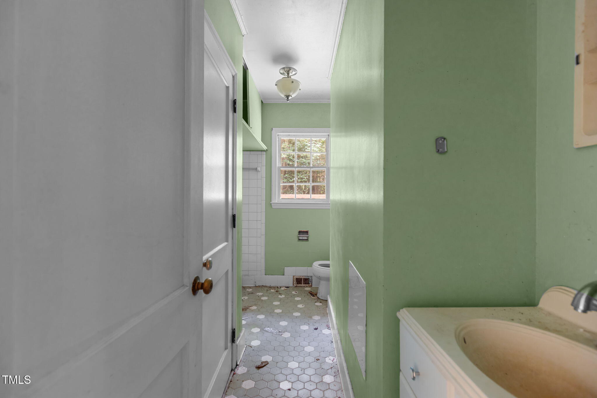 1409 Trailwood Drive Raleigh, NC 27606 - Photo 11 of 32 a bathroom with a sink and toilet
