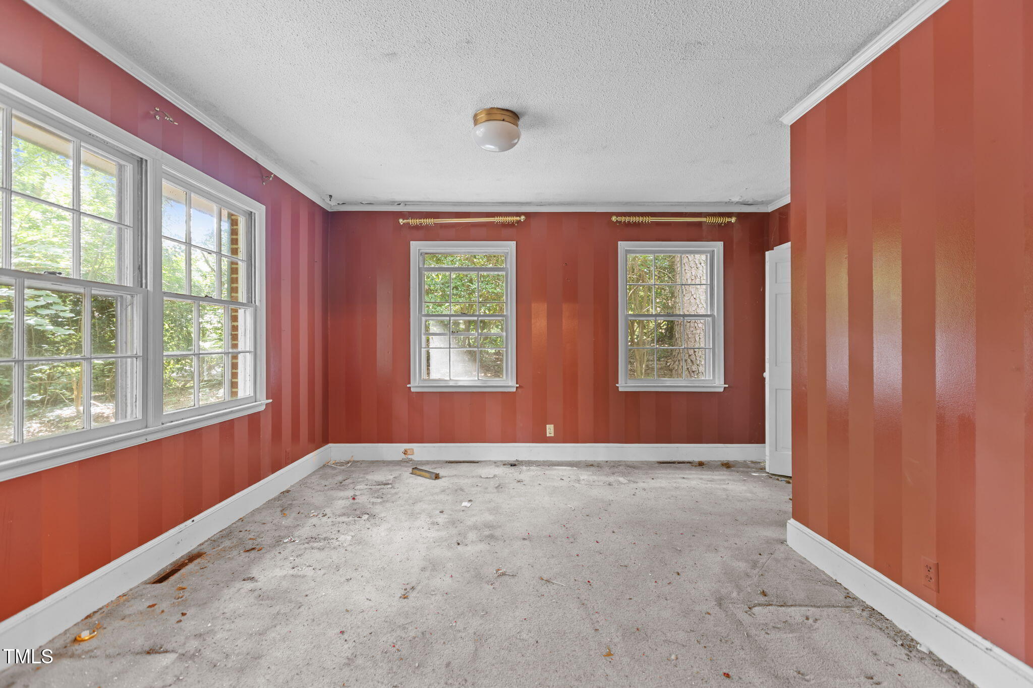 1409 Trailwood Drive Raleigh, NC 27606 - Photo 20 of 32 an empty room with windows