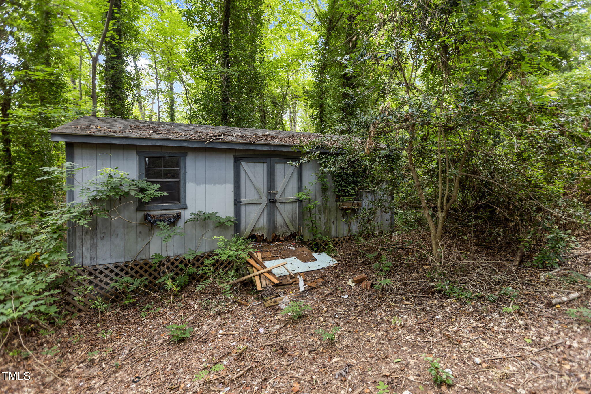 1409 Trailwood Drive Raleigh, NC 27606 - Photo 25 of 32 a backyard of a house with table and chairs