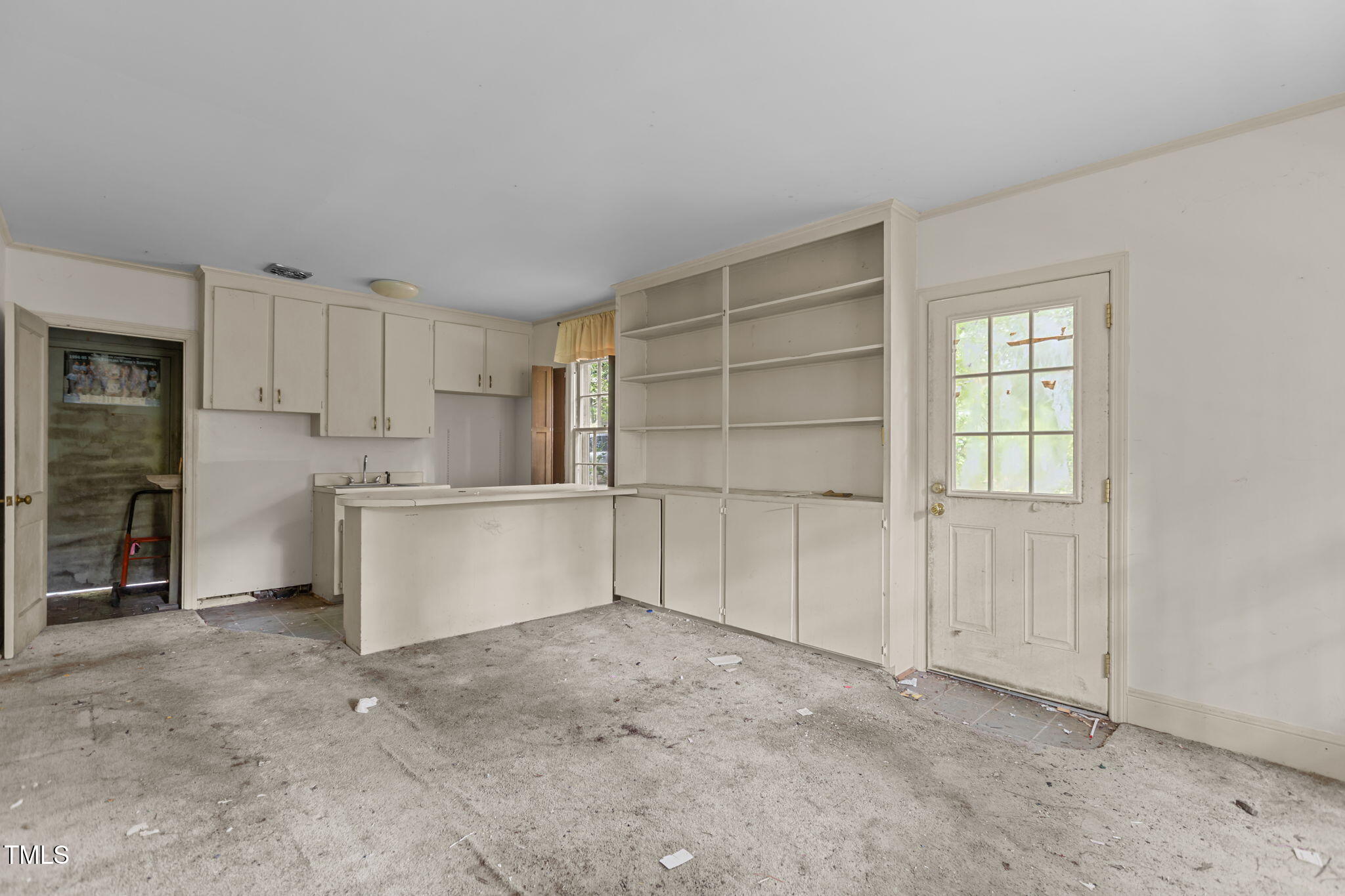 1409 Trailwood Drive Raleigh, NC 27606 - Photo 5 of 32 a view of a kitchen with a sink and a refrigerator