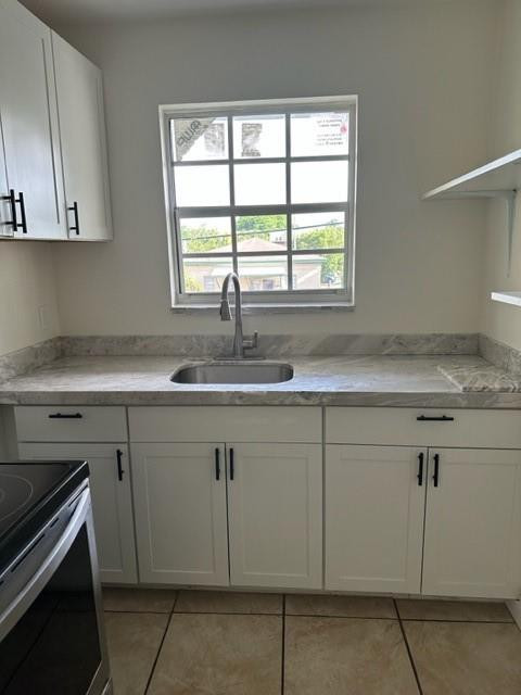 Undisclosed Address Miami, FL 33128 - Photo 11 of 23 a kitchen with granite countertop white cabinets and a sink
