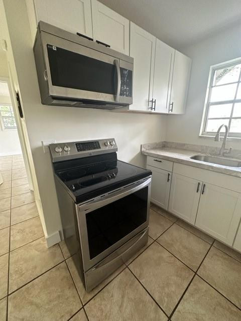 Undisclosed Address Miami, FL 33128 - Photo 12 of 23 a kitchen with a stove and a microwave