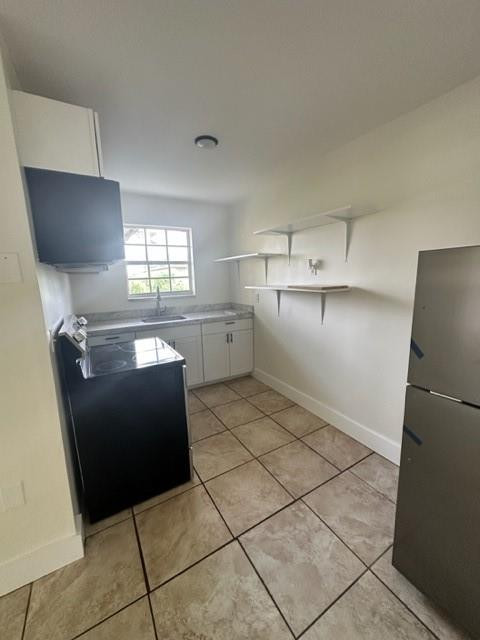 Undisclosed Address Miami, FL 33128 - Photo 9 of 23 a kitchen with a refrigerator and a sink