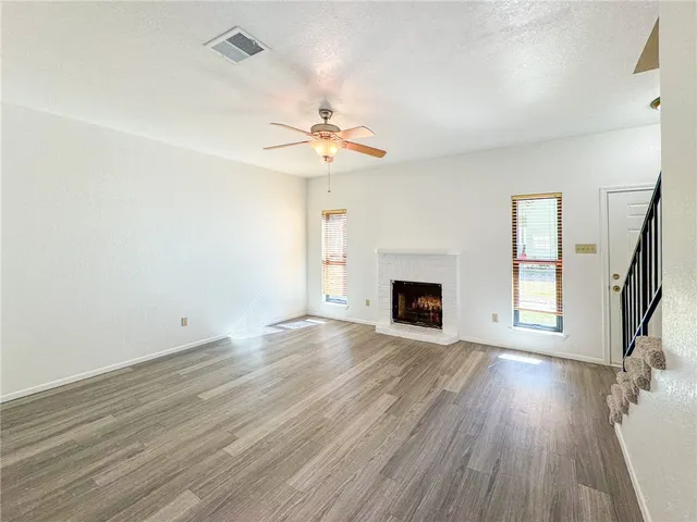 wooden floor in an empty room with a fireplace
