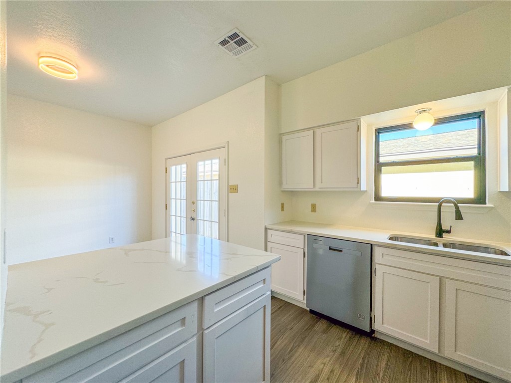 2916 St Joseph Street, Unit D Corpus Christi, TX 78418 - Photo 10 of 30 a kitchen with a sink cabinets and wooden floor
