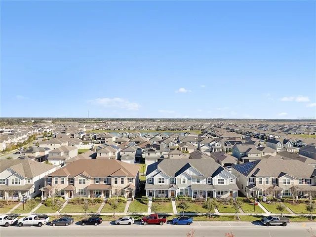 an aerial view of residential houses with city view