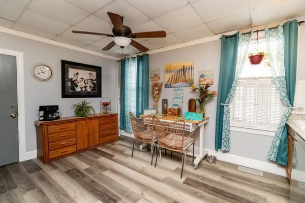 a living room with furniture a flat screen tv and a table