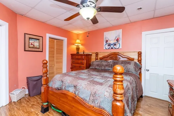 a bedroom with a bed and a chandelier