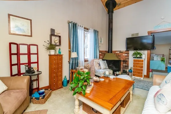 a living room with furniture a flat screen tv and a table