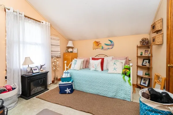 a bedroom with a bed and a couch