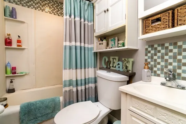 a white toilet sitting next to a bathroom sink