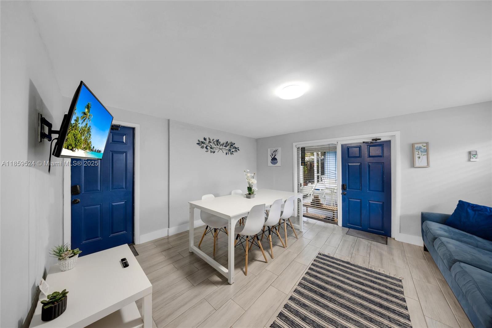 817 Southwest 12th Avenue Fort Lauderdale, FL 33315 - Photo 12 of 37 a living room with furniture a dining table and paintings on the wall