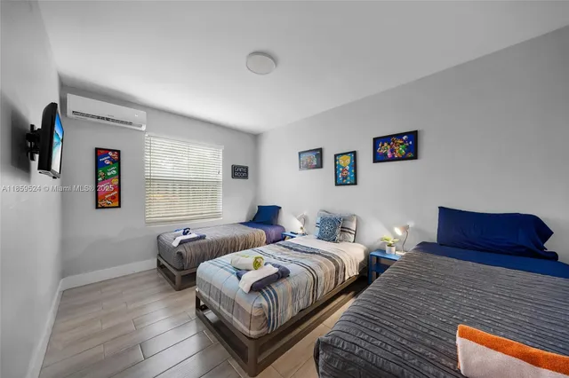 a bedroom with two beds and a window