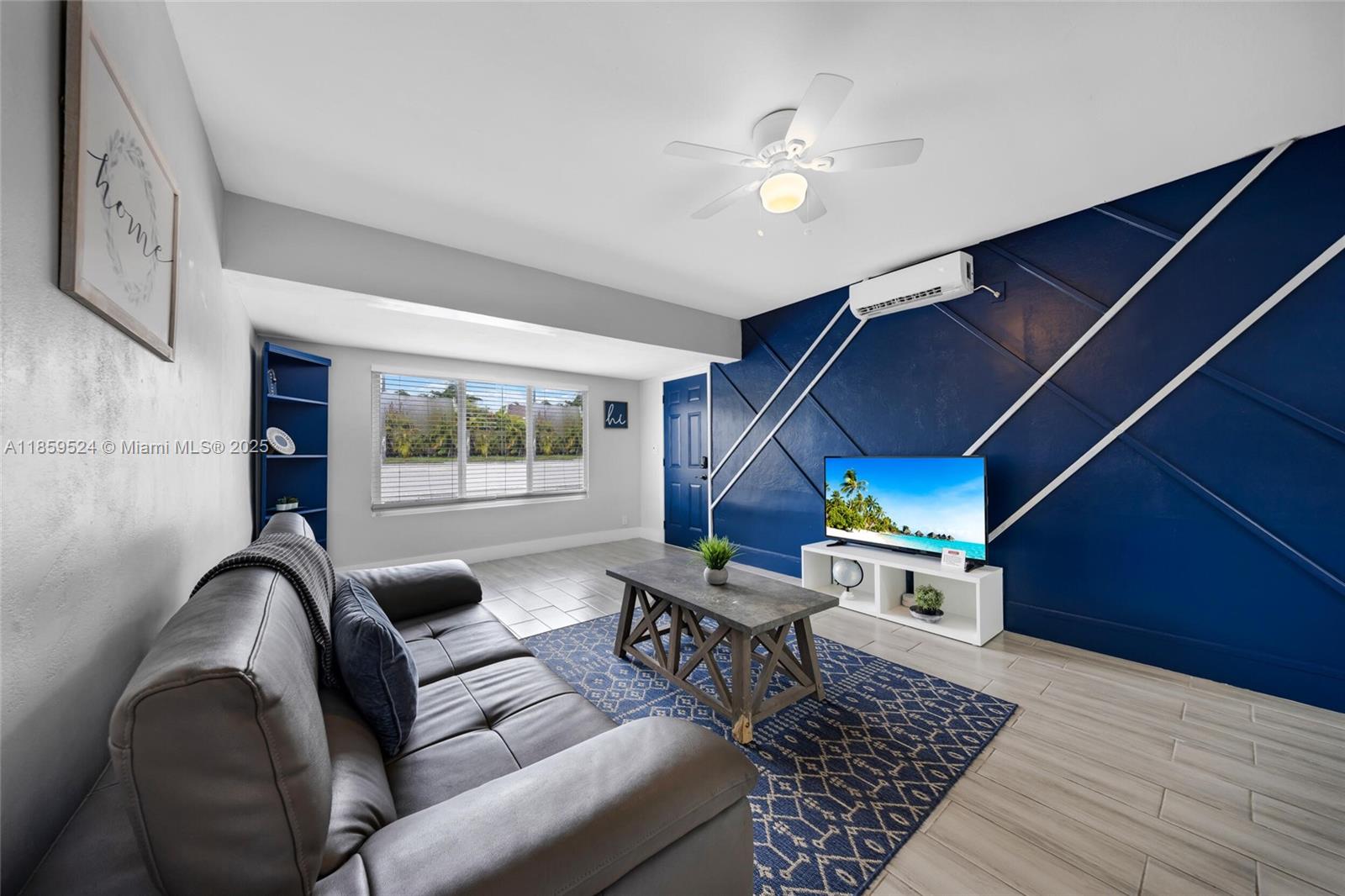 817 Southwest 12th Avenue Fort Lauderdale, FL 33315 - Photo 2 of 37 a living room with furniture and a floor to ceiling window