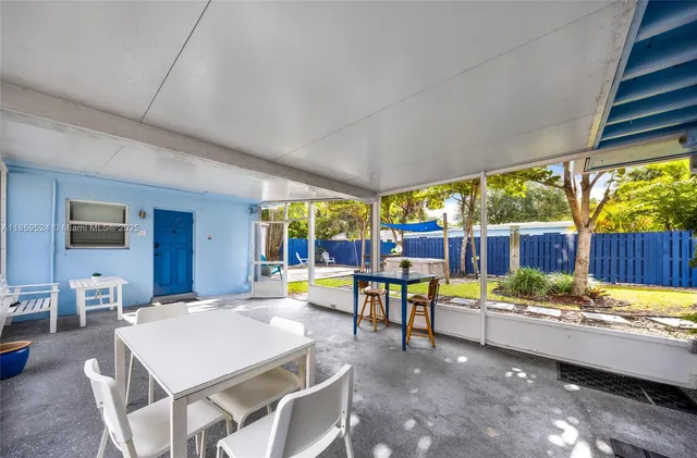 a view of a dining table and chairs in the patio