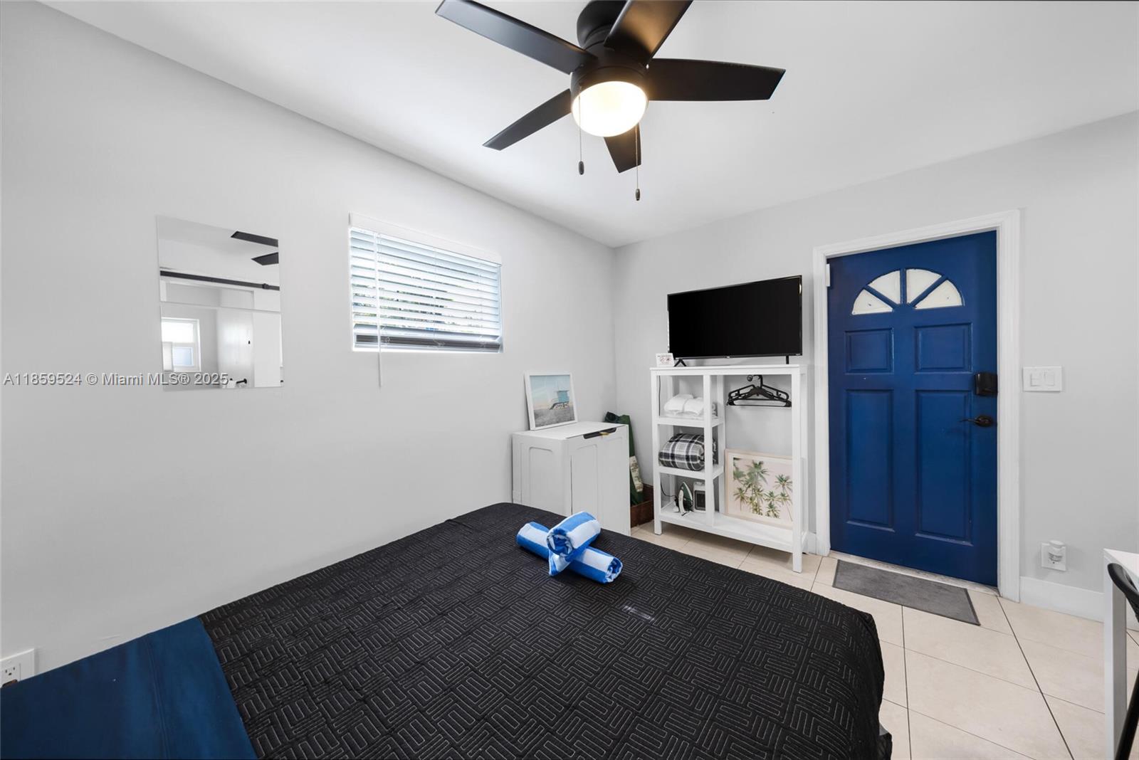 817 Southwest 12th Avenue Fort Lauderdale, FL 33315 - Photo 32 of 37 a bedroom with a bed and a flat screen tv