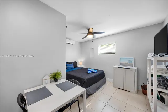 a bedroom with furniture and a window