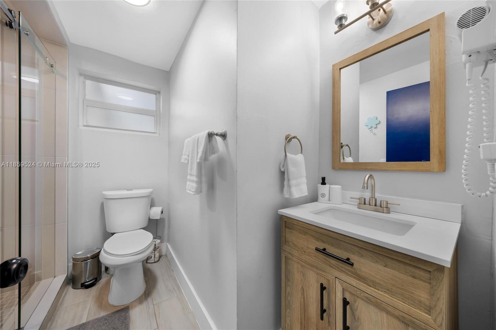 817 Southwest 12th Avenue Fort Lauderdale, FL 33315 - Photo 7 of 37 a bathroom with a toilet sink and mirror