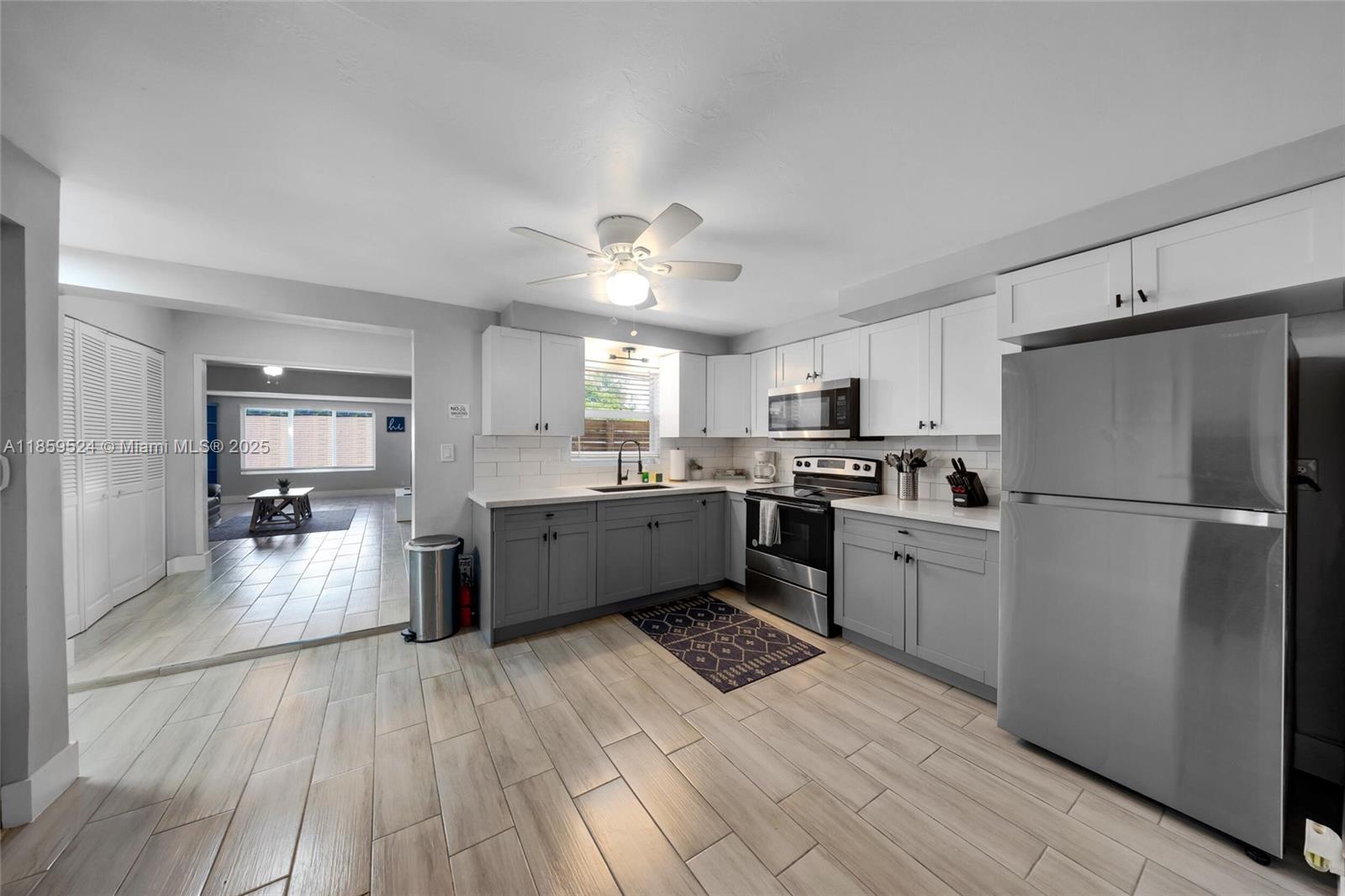 817 Southwest 12th Avenue Fort Lauderdale, FL 33315 - Photo 10 of 37 a kitchen with a refrigerator cabinets and wooden floor