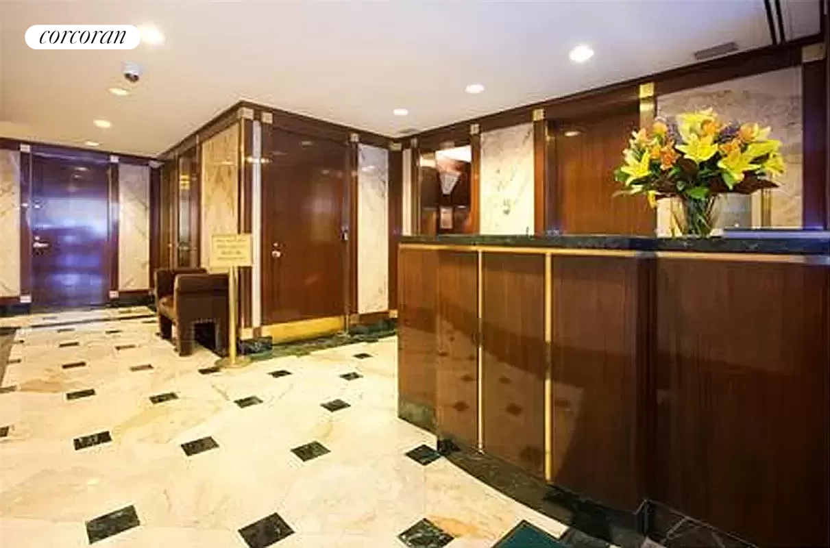 205 East 68th Street, Unit T5B Manhattan, NY 10065 - Photo 3 of 8 a bathroom with sink mirror and shower