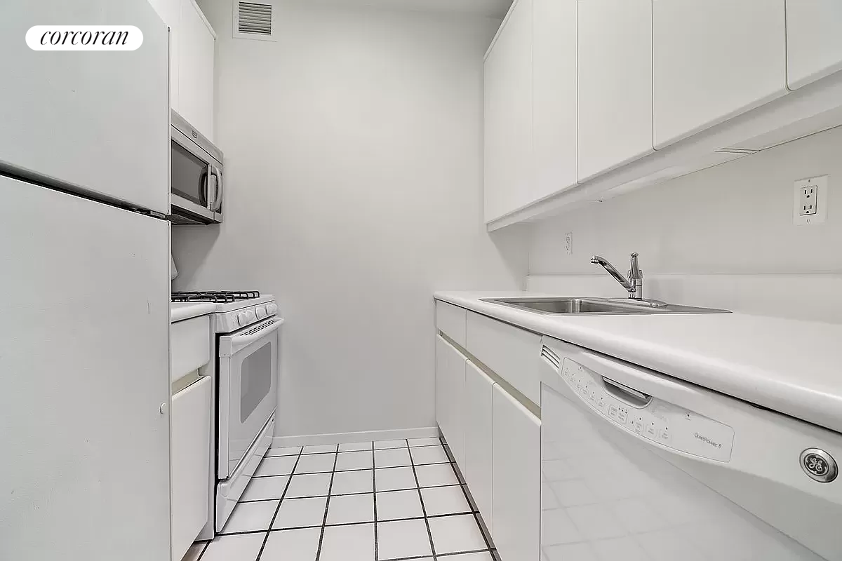205 East 68th Street, Unit T5B Manhattan, NY 10065 - Photo 7 of 8 a kitchen with a sink stove and refrigerator