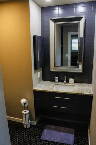 a bathroom with a sink and a mirror