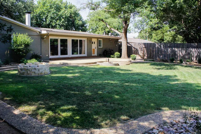a front view of house with a garden and patio