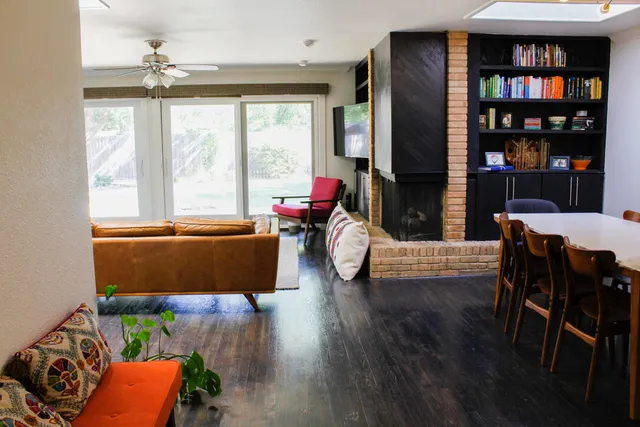 a living room with furniture and a floor to ceiling window