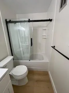 a view of a room with wooden floor and window