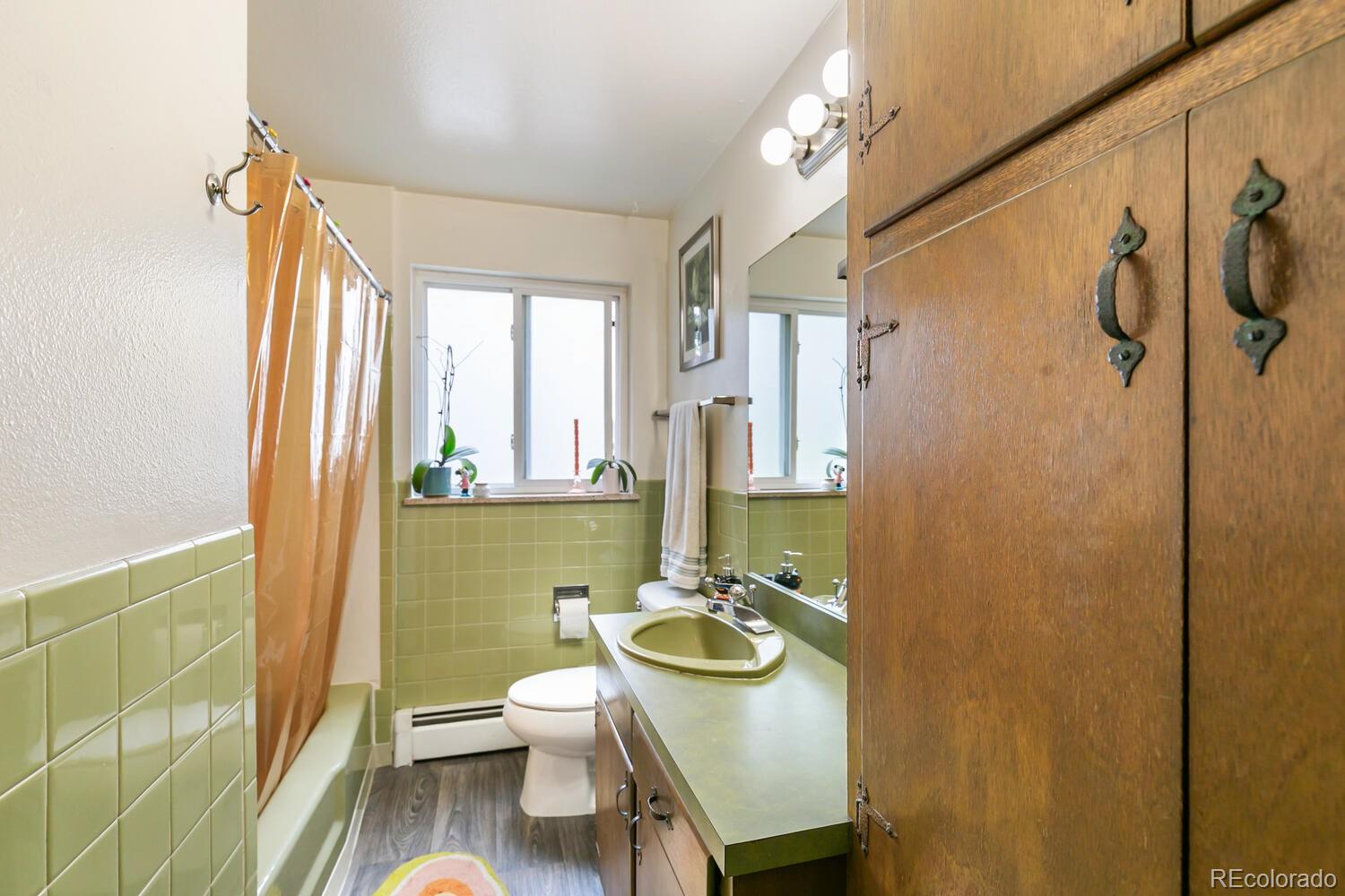 3820 Xavier Street Denver, CO 80212 - Photo 14 of 35 a bathroom with a sink a toilet and a mirror