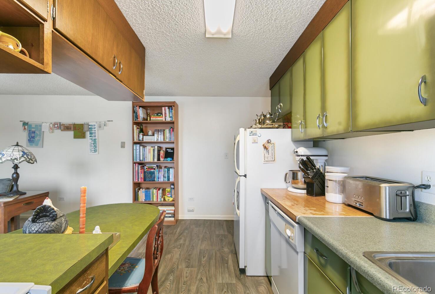 3820 Xavier Street Denver, CO 80212 - Photo 16 of 35 a living room with stainless steel appliances furniture a rug and a kitchen view
