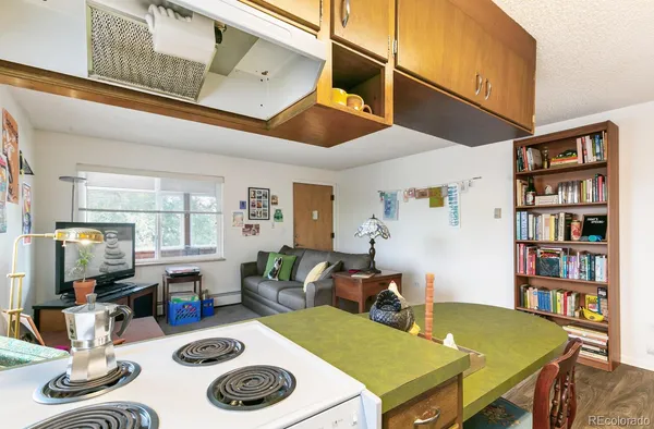 a kitchen with a refrigerator a stove a sink dishwasher with a dining table and chairs