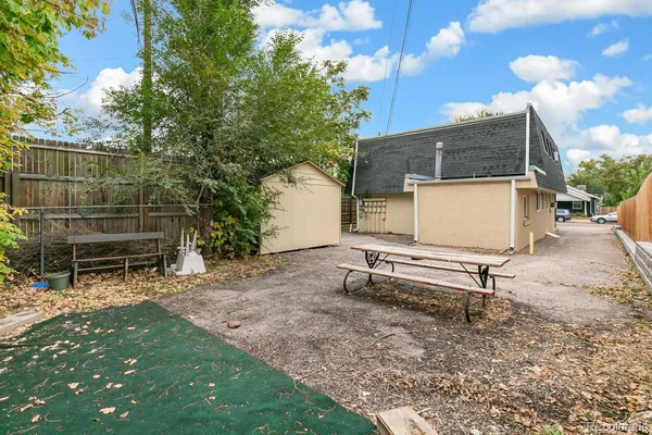 a view of backyard with wooden fence