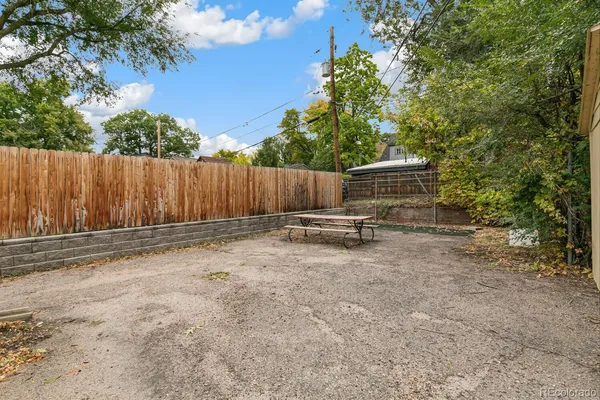 a view of a house with a backyard and garage