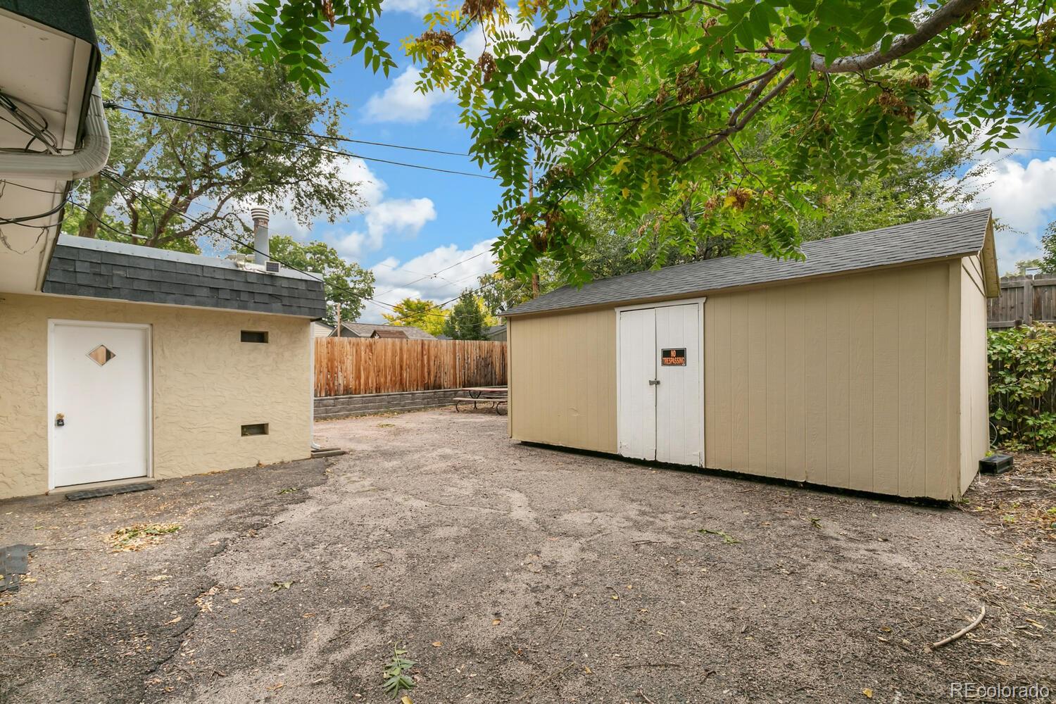 3820 Xavier Street Denver, CO 80212 - Photo 7 of 35 a view of a house with a backyard and garage