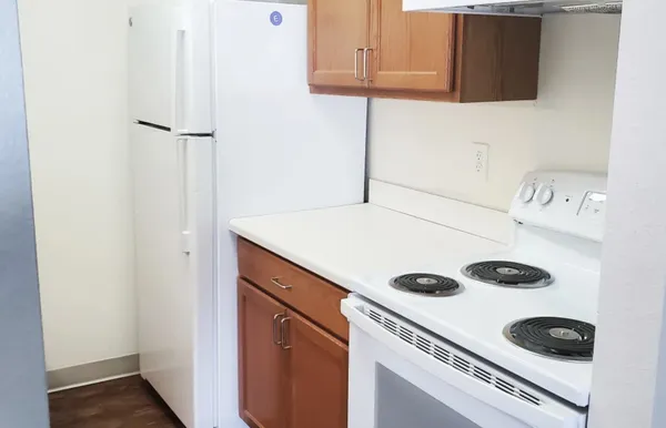 a kitchen with a refrigerator and a stove