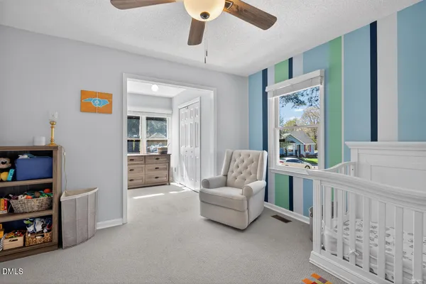 a bedroom with furniture and a large window