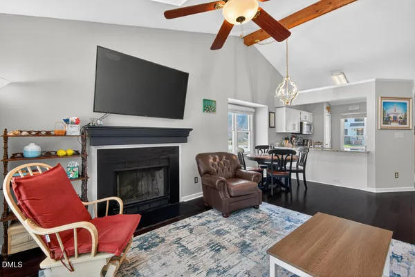 a view of a dining room with furniture a chandelier and wooden floor