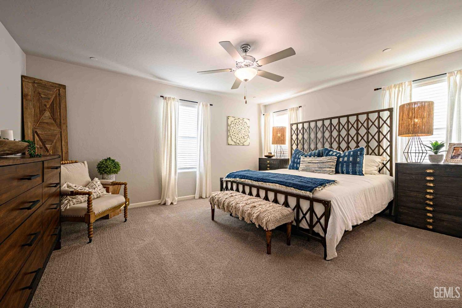 Undisclosed Address Bakersfield, CA 93313 - Photo 10 of 21 a bedroom with a bed and a chandelier