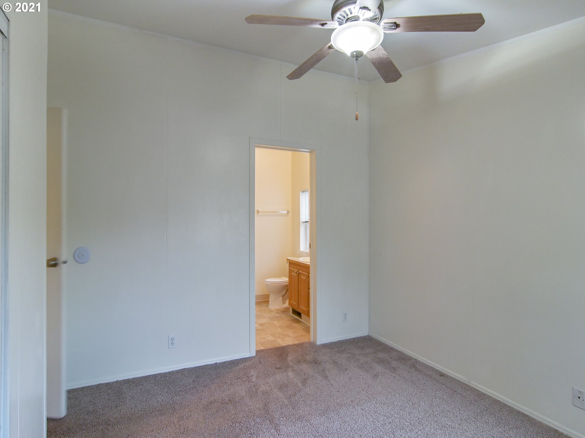 469 48th Street Springfield, OR 97478 - Photo 20 of 32 an empty room with a chandelier fan and a window