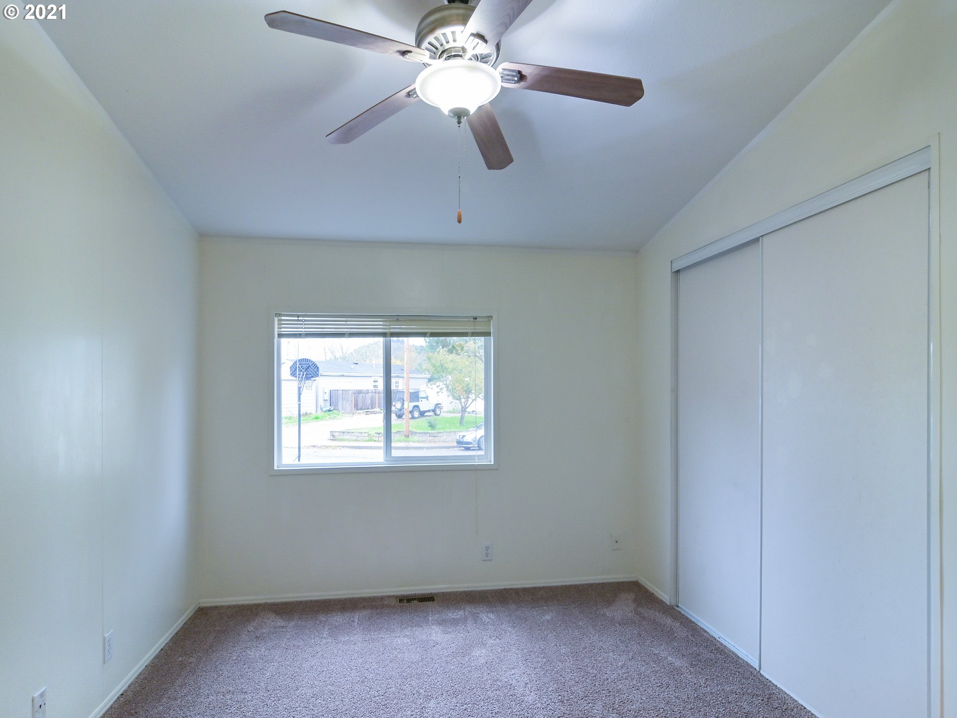 469 48th Street Springfield, OR 97478 - Photo 22 of 32 an empty room with a window and a fan