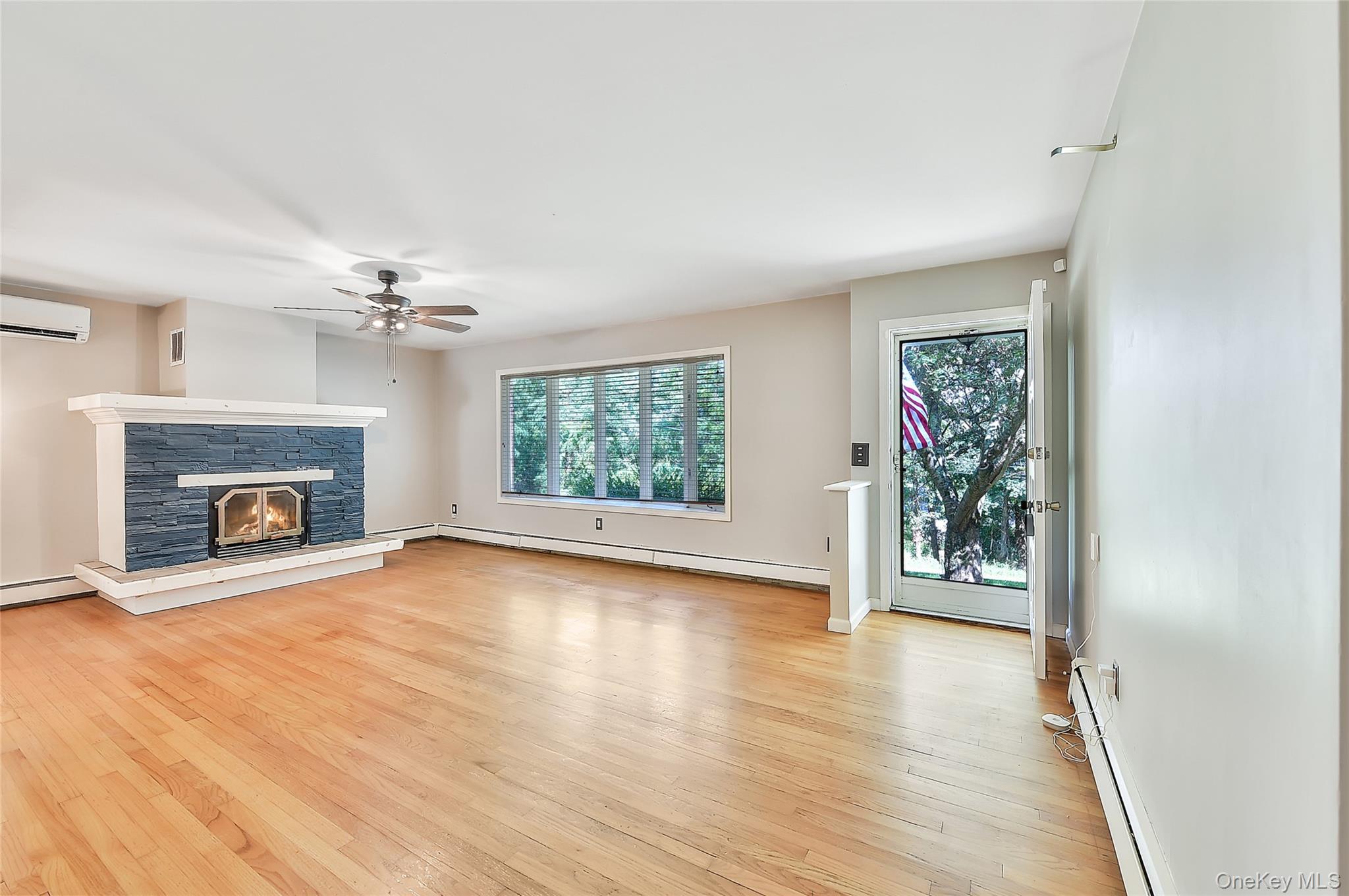 18 Stage Road Pine Island, NY 10969 - Photo 13 of 42 wooden floor fireplace and windows in an empty room