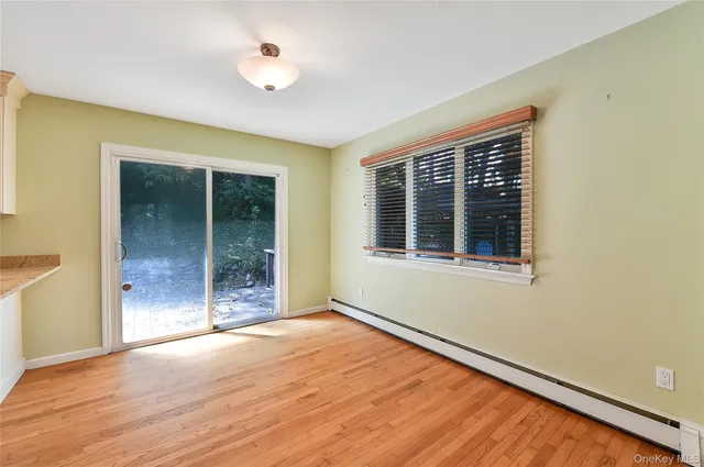 a view of an empty room with glass door and a window