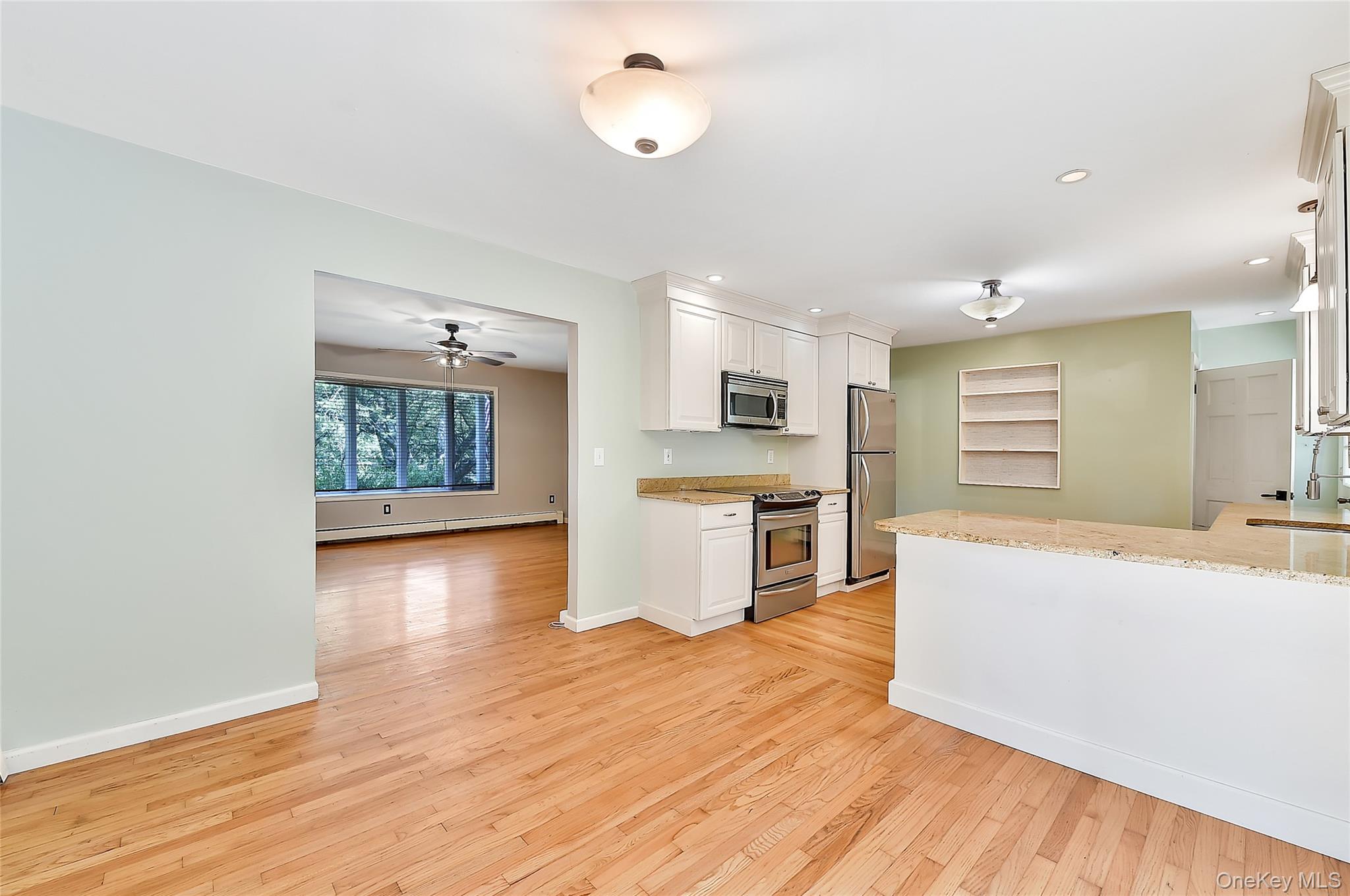 18 Stage Road Pine Island, NY 10969 - Photo 18 of 42 a large living room with stainless steel appliances wooden floors and view living room