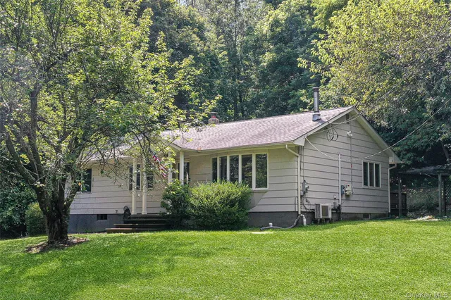 a backyard of a house with table and chairs