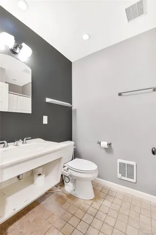 a bathroom with a sink toilet and vanity