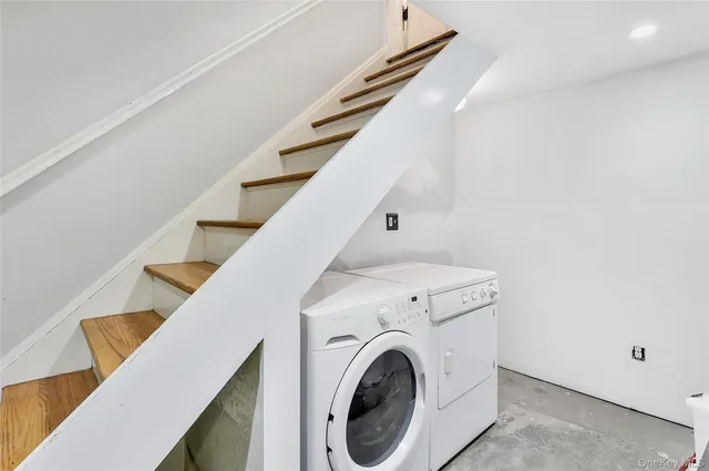 a view of washer and dryer with kitchen in the background